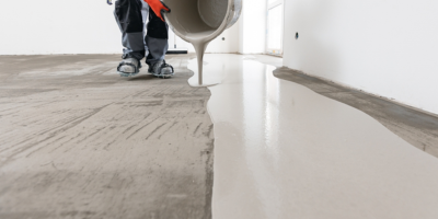 Smooth self-leveling compound being applied to a floor